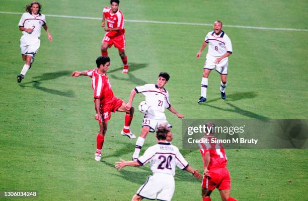 Mehdi Pashazadeh of Iran and Claudio Reyna of USA in action during the World Cup 1st round match between USA and Iran at the Parc Olympique on June...