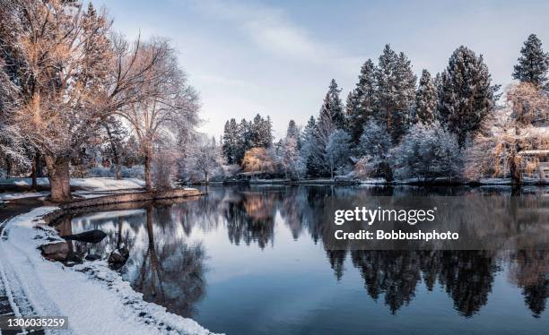 snowy morning on deschutes river in bend, oregon - mirror pond oregon stock pictures, royalty-free photos & images