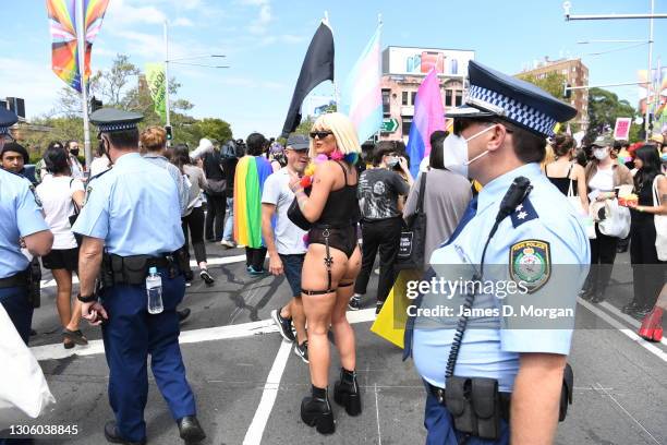 Police officers wearing face masks overseeing protesters beofre they march ahead of the Sydney Gay and Lesbian Mardi Gras parade as they campaign for...