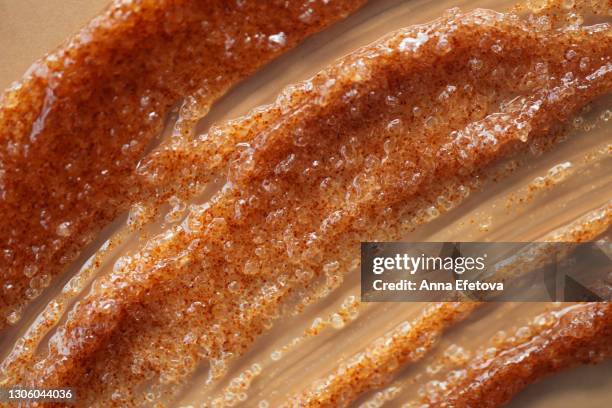 texture of orange coffee and sugar scrub's smear with exfoliating particles on beige background. concept of self-care and beauty treatment. selfcare is a trendy procedure of the year. cosmetics web banner - caramel sauce stock pictures, royalty-free photos & images