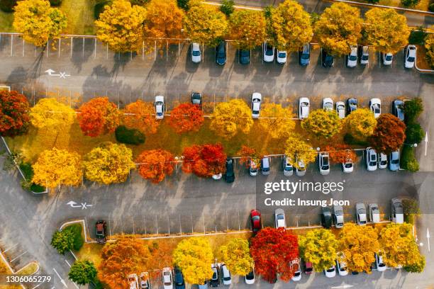 aerial view of cars parked in parking lot during - car park stock-fotos und bilder