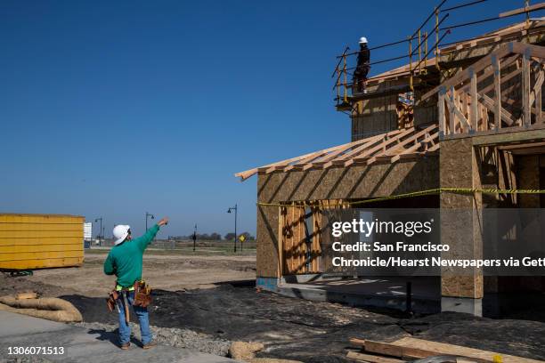 Workers build a home at the planned community at River Islands in Lathrop, California Thursday, Mar. 4, 2021. The pandemic-driven desire for more...