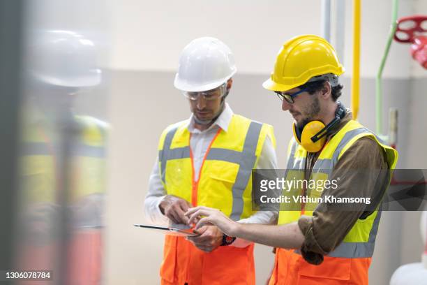 operation engineer working in industrial plant with tablet - energy industry heat steam stock pictures, royalty-free photos & images