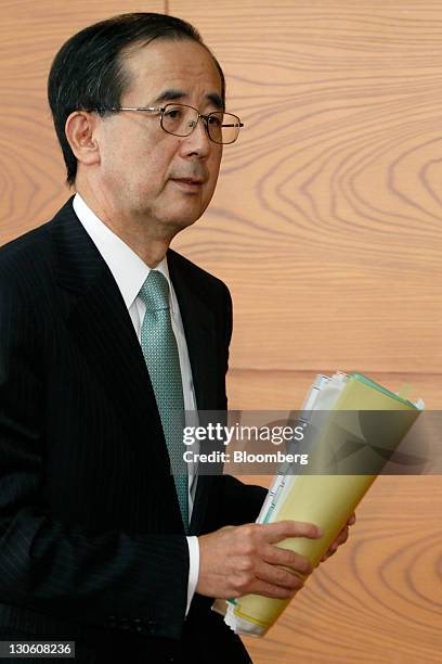 Masaaki Shirakawa, governor of the Bank of Japan, leaves a news conference at the central bank's headquarters in Tokyo, Japan, on Thursday, Oct. 27,...