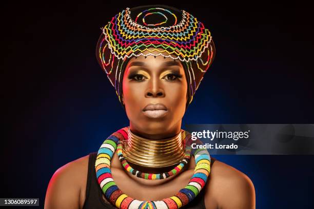 headshot portrait of a beautiful african queen wearing a headdress - african queen stock pictures, royalty-free photos & images