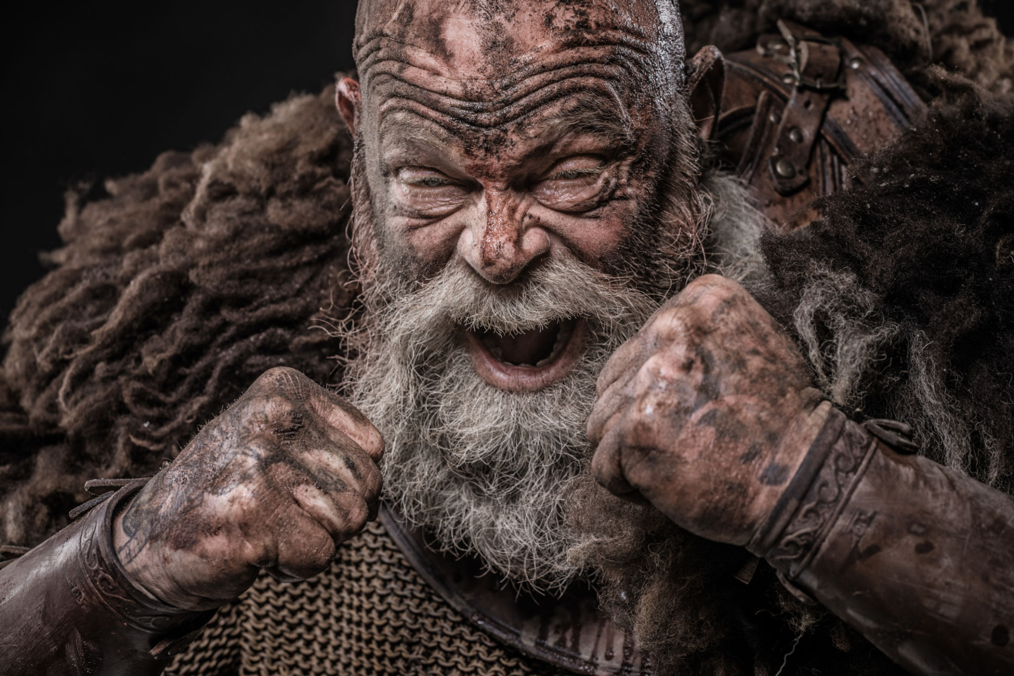 Weapon wielding senior viking warrior in studio shot Weapon wielding senior viking warrior in studio shot
