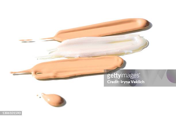 abstract smudged smears of cosmetic tonal cream foundation cream and lip gloss. - foundation make up stock-fotos und bilder