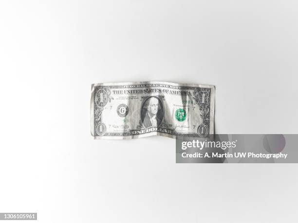 crumpled dollar bill on a white background - us paper currency stock pictures, royalty-free photos & images