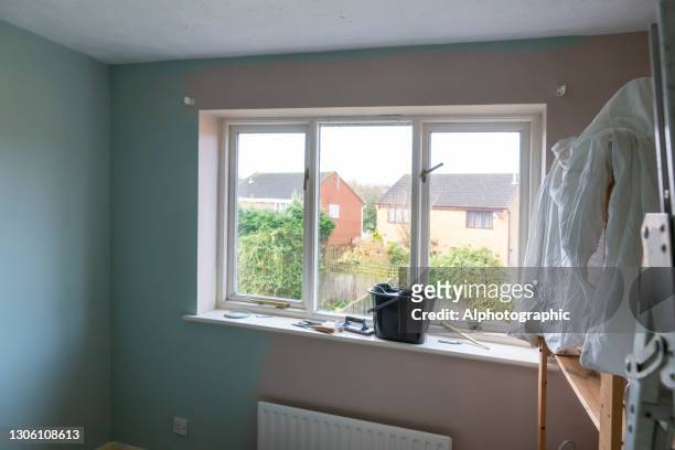 room being repainted with dustsheets over furniture - january 2021 stock pictures, royalty-free photos & images