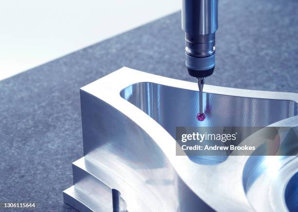 engineering metrology, a probe from a coordinate measurement machine taking measurements from a engineering part as part of its quality control process in manufacturing - metrology stock pictures, royalty-free photos & images