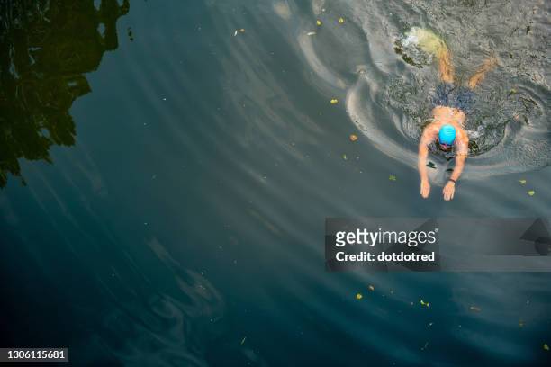 man wild swimming in river, overhead view, river wey, surrey, uk - outdoor swimming stock pictures, royalty-free photos & images