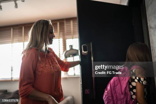 mother watching daughter going to school - love is an open door stock pictures, royalty-free photos & images