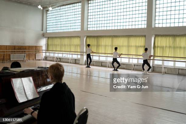 Pianist plays while ballet students warm up before a class session on March 09, 2021 in Bishkek, Kyrgyzstan. Bishkek Choreographic School was founded...