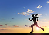 Female athlete running at sunset