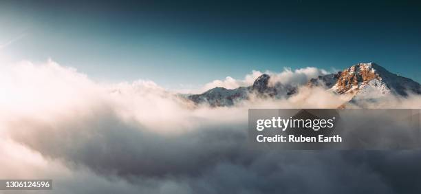 aerial mountain landscape during sunrise panoramic view - mountain peak above clouds stock pictures, royalty-free photos & images
