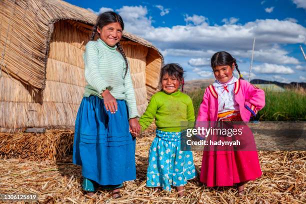 happy children on uros floating island, lake tititcaca, peru - peruvian culture stock pictures, royalty-free photos & images