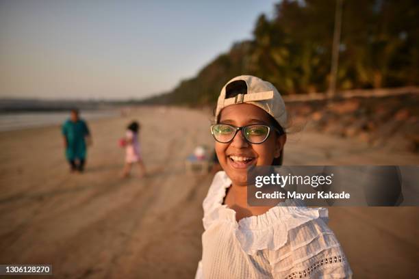 portrait of a smiling girl on beach - indian family vacation stock pictures, royalty-free photos & images