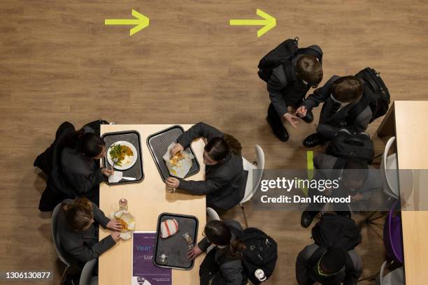 Pupils eat lunch in the canteen on their first day back from lockdown at Chertsey High School on March 09, 2021 in Chertsey, United Kingdom. Chertsey...