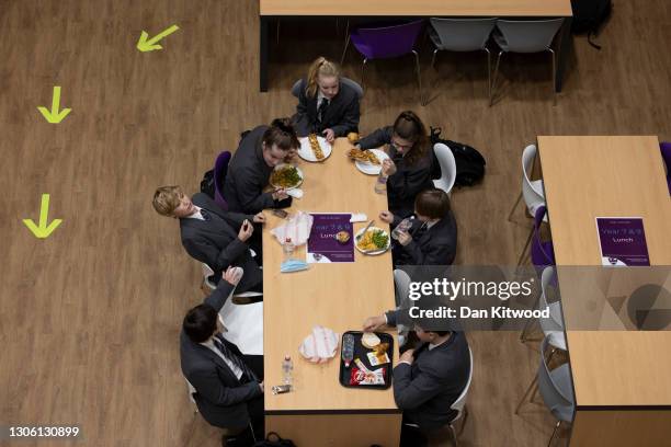 Pupils eat lunch in the canteen on their first day back from lockdown at Chertsey High School on March 09, 2021 in Chertsey, United Kingdom. Chertsey...