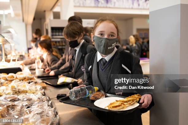 Pupils collect lunch in the canteen on their first day back from lockdown at Chertsey High School on March 09, 2021 in Chertsey, United Kingdom....