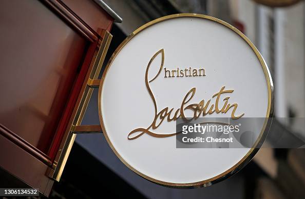 A Christian Louboutin logo is on display on the luxury shoe store