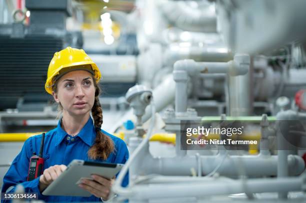 female engineer are conduct process safety inspection the boiling system by using digital tablet in boiler control room. the hvac ( heating, ventilation and air conditioning ) control systems. - leading indicators stock pictures, royalty-free photos & images
