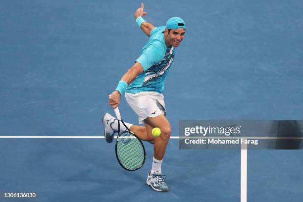 Malek Jaziri of Tunisia stretches to play a backhand in his Round One match against Norbert Gombos of Slovakia during Day Two of the Qatar ExxonMobil...