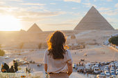 Woman standing on the  terrace on the  background of Giza pyramids