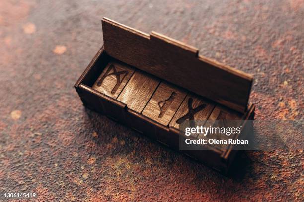 wooden runes with carved letters in box - rune symbols stock pictures, royalty-free photos & images