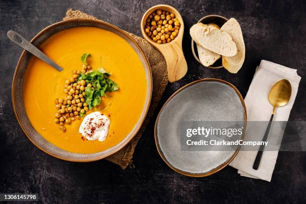creamy carrot and parsnip soup with roasted chickpeas. - creme fraiche stock pictures, royalty-free photos & images
