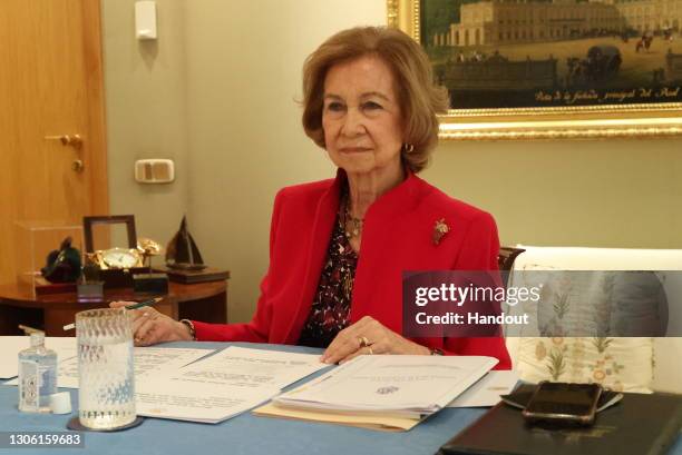 In this handout photo provided by Casa de S.M. El Rey Spanish Royal Household, Queen Sofia of Spain takes part in a video conference with the board...
