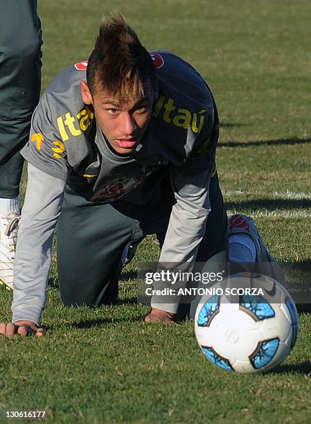 Brazilian footballer Neymar looks at the ball after falling, during a training session on July 5 in Campana, 70 Km north from Buenos Aires. Brazil...