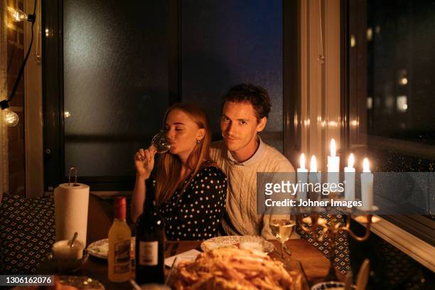 young couple sitting together at table - dating stock pictures, royalty-free photos & images