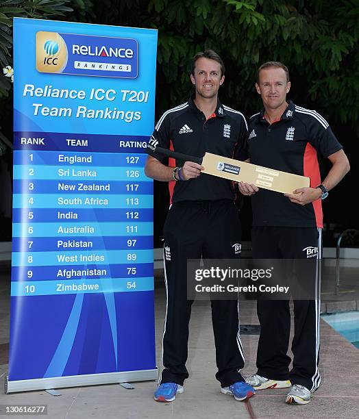 England captain Graeme Swann and coach Andy Flower are presented with a gold bat after been announced as the number one in the new ICC 20Twenty team...