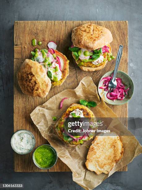 high angle view of burgers on wooden board - burger top view stock pictures, royalty-free photos & images