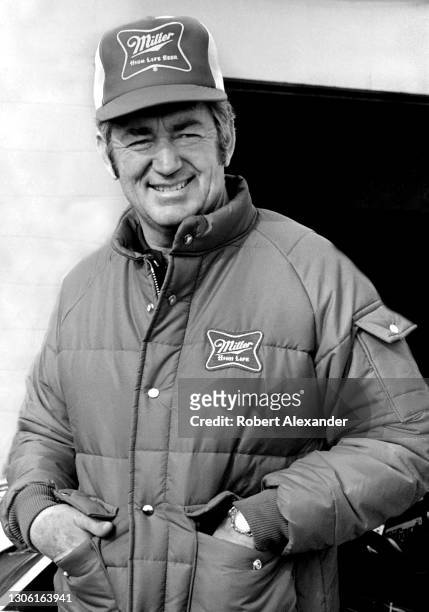 Driver Bobby Allison relaxes in the speedway garage area prior to the start of the 1983 Daytona 500 stock car race at Daytona International Speedway...