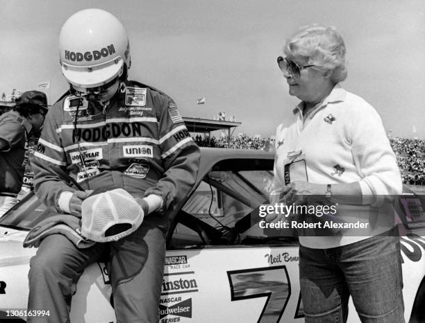 Driver Neil Bonnett signs an autograph prior to the start of the 1984 Daytona 500 stock car race at Daytona International Speedway in Daytona Beach,...