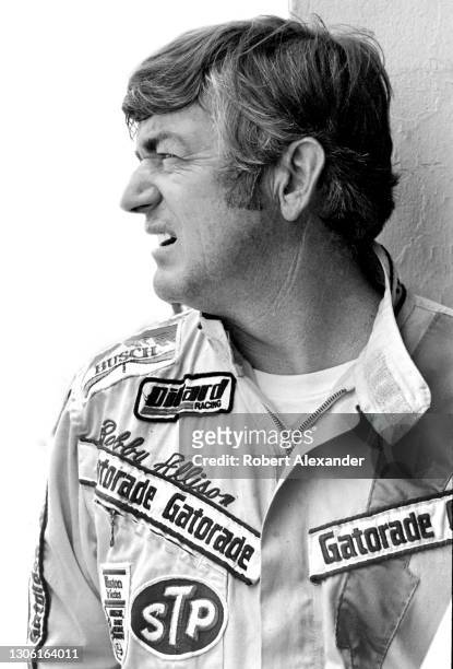 Driver Bobby Allison stands in the speedway garage area prior to the start of the 1982 Daytona 500 stock car race at Daytona International Speedway...