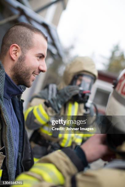 smiling firefighter talking - rescue worker stock pictures, royalty-free photos & images