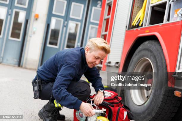 female firefighter checking equipment - nacka sweden stock pictures, royalty-free photos & images