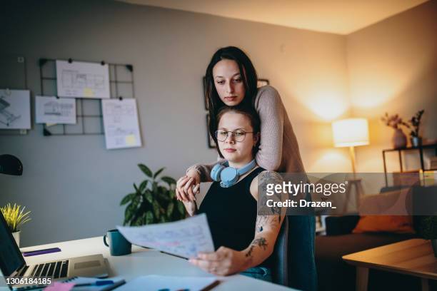 Gen-Z lesbian couple working from home and sharing love
