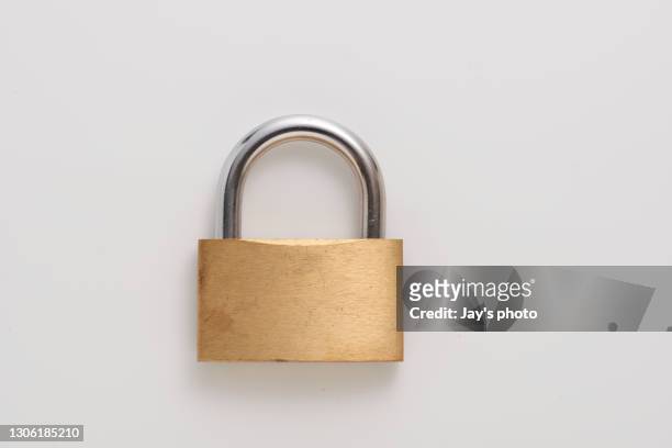 metal padlock on white background - stock photo - guarding stock-fotos und bilder