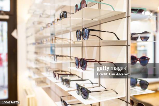 variety of fashionable sunglasses on store display - visual merchandise stock pictures, royalty-free photos & images