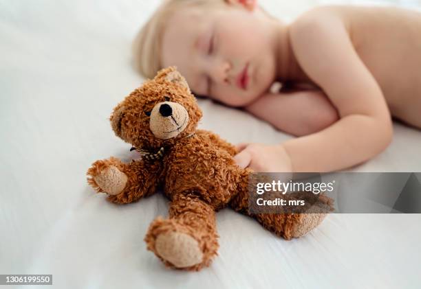 small boy sleeping with teddy bear - soft toy fotografías e imágenes de stock