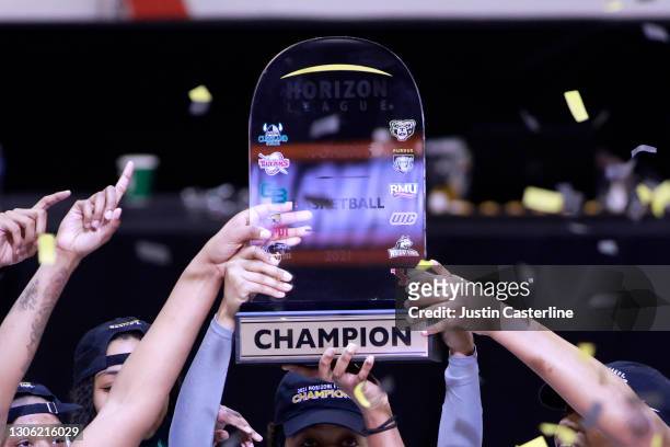 The Wright State Raiders hold up the Horizon League trophy after winning the Horizon League Women's Basketball Championship against the IUPUI Jaguars...