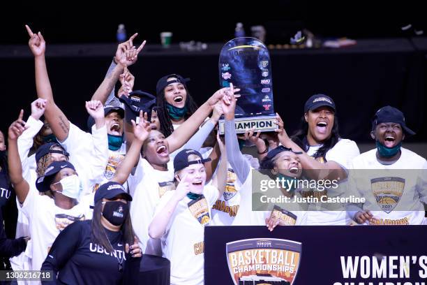 The Wright State Raiders hold up the Horizon League trophy after winning the Horizon League Women's Basketball Championship against the IUPUI Jaguars...