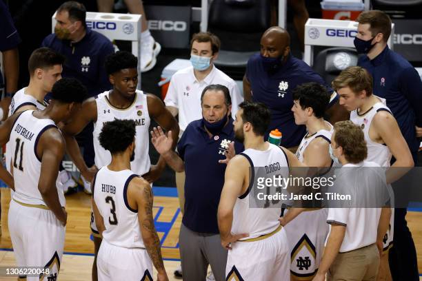 Head coach Mike Brey of the Notre Dame Fighting Irish speaks with his team under a timeout during the first half of their first round game against...