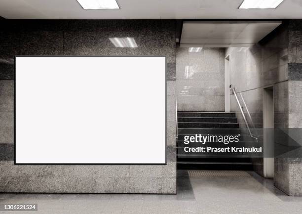blank billboard located in underground hall or subway for advertising, mockup concept - placard stockfoto's en -beelden