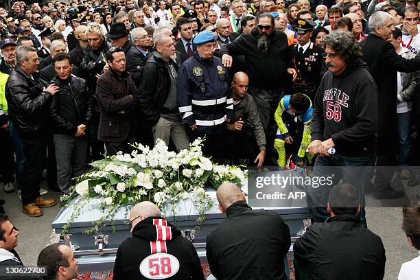 Paopo Simoncelli stands at the coffin of his son, Italian MotoGP rider Marco Simoncelli during his funerals on October 27, 2011 in Coriano, in the...
