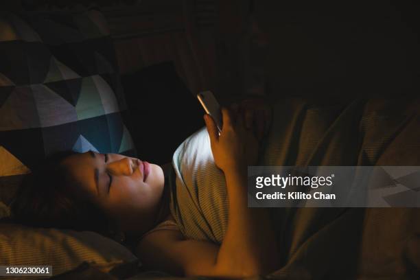 asian woman fall asleep while using phone - sleep female handphone stock-fotos und bilder
